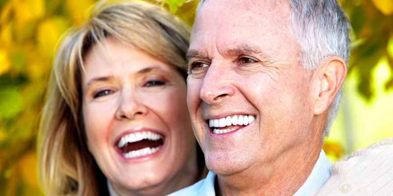 Couple laughing with dental bridge